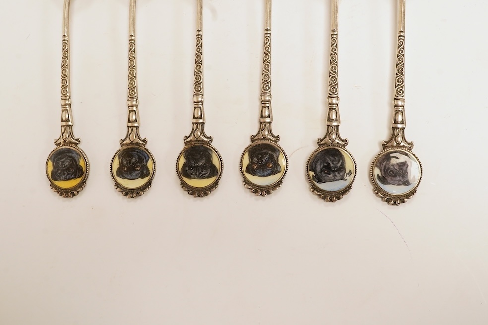 A matched set of six mainly George V silver/white metal and enamel teaspoons, with terminals decorated with dog's heads, 13.6cm. Condition - fair